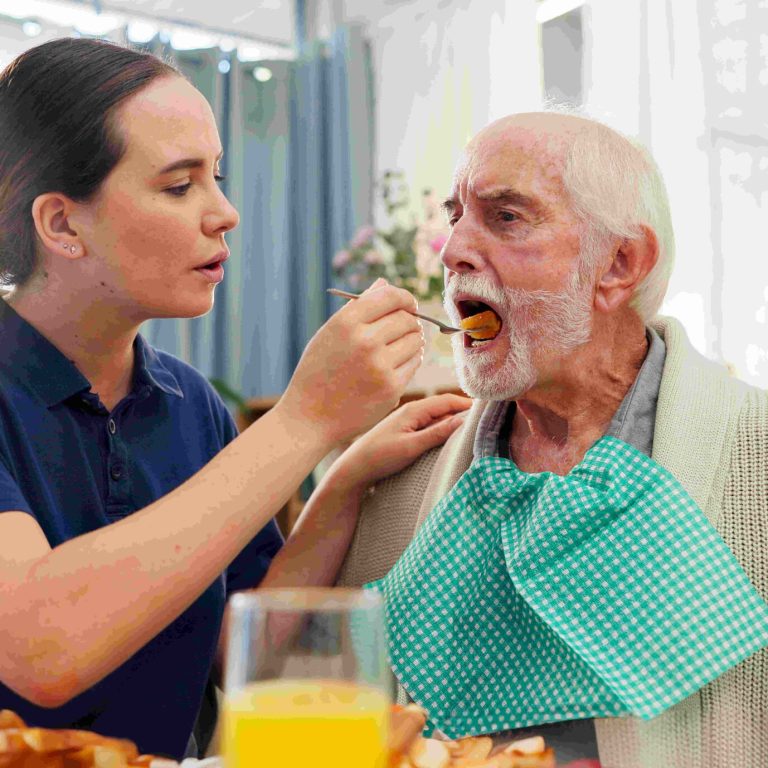 Feeding, nurse or senior man in nursing home for elderly care, nutrition or support. Retired male p.