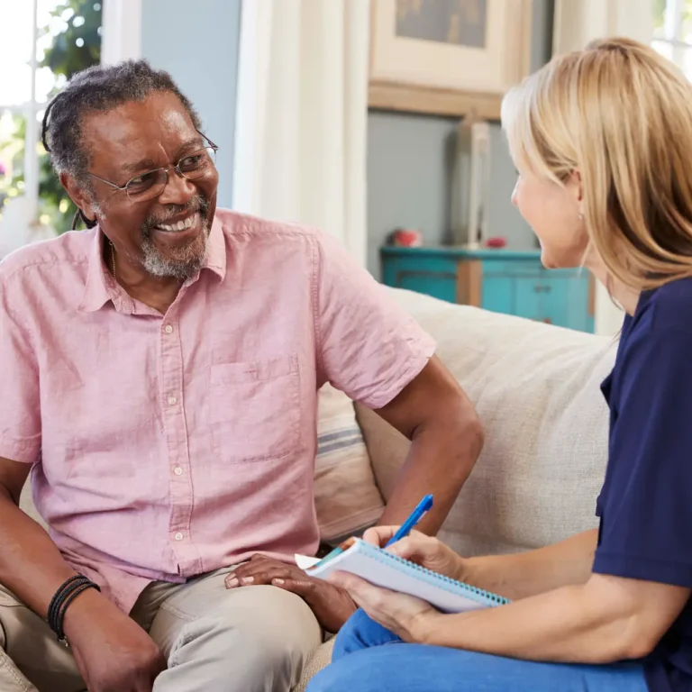 Female Support Worker Visits Senior Man At Home Female Support Worker Visits Senior Man At Home