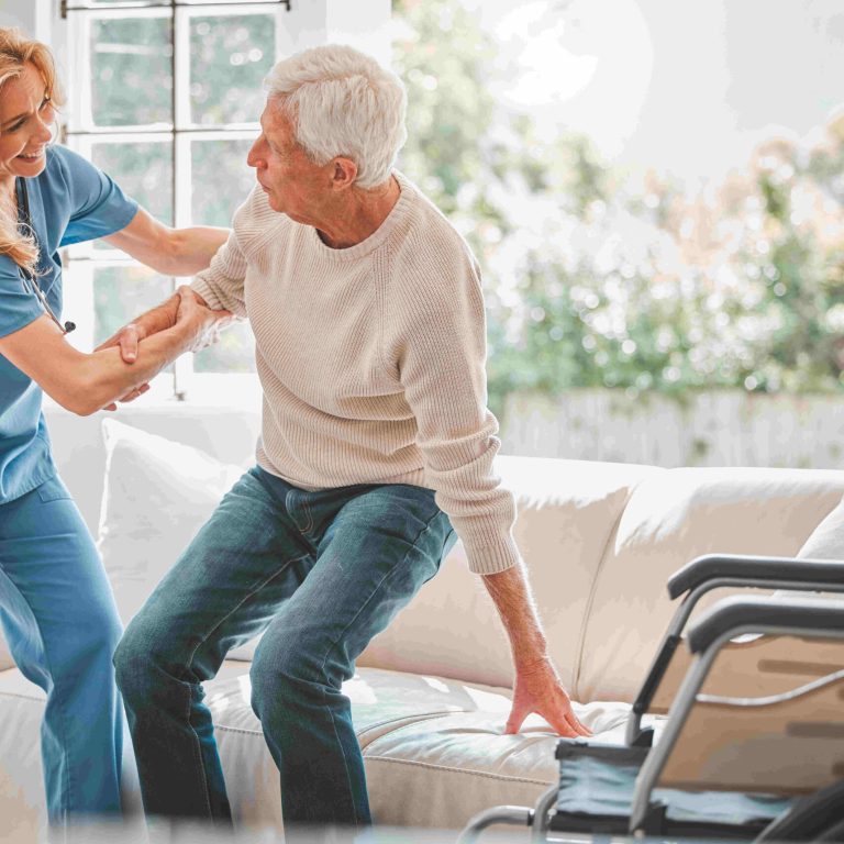 Slow and steady will win the race. Shot of a young nurse helping her elderly male patient stand up